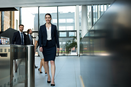 Portrait of a confident businesswoman walking in officeの写真素材