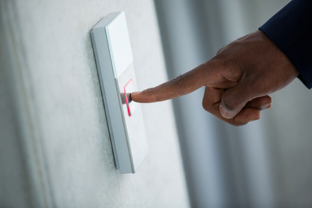 Close-up of hand of a businessman pressing the elevator button