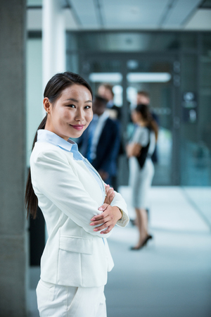 Portrait of businesswoman standing with her arms crossedの写真素材