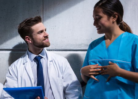 Doctor and nurse having a conversation in hospitalの写真素材