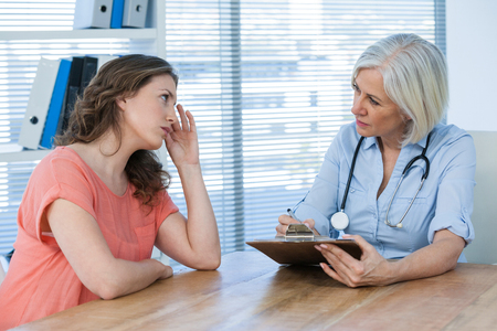 Doctor interacting with patient at the hospitalの写真素材