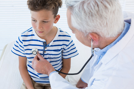 Doctor examining a patient in clinicの写真素材