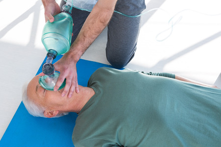 Paramedic performing resuscitation on patient in clinic