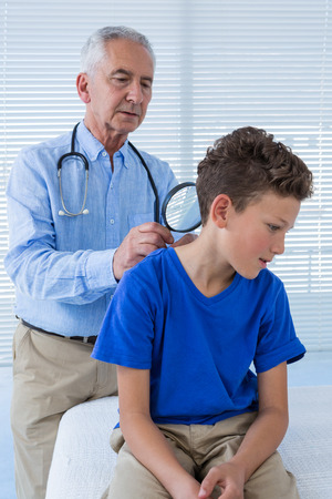 Doctor examining the patient in clinicの写真素材