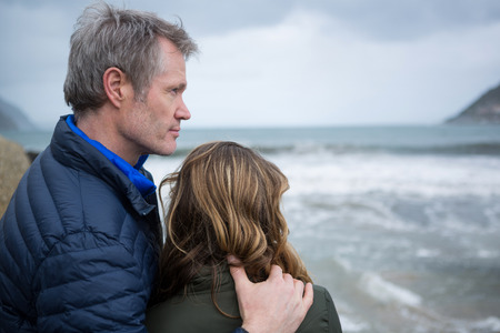 Romantic couple enjoying the view of the beachの写真素材
