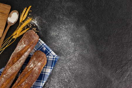 Bread loaf with wheat grains and scoop of flour