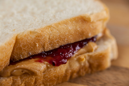 Close-up of bread sandwich with jam and peanut butter