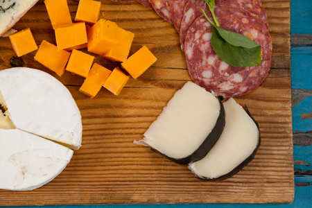 Close-up of various cheese with ham on chopping boardの写真素材