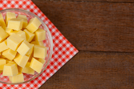Close-up of cheese cubes in bowl on cloth napkinの写真素材