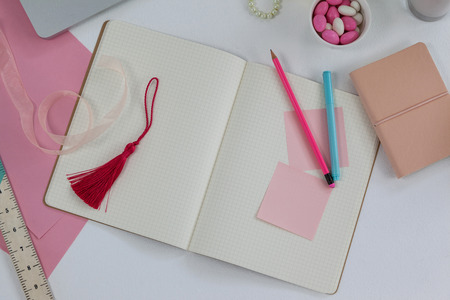 Diary, bookmark, ruler, ribbon, pencil and sticky notes on deskの写真素材