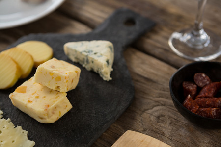 Close-up of variety of cheese on slate plate