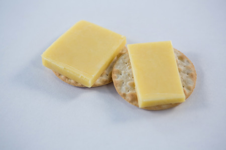Close-up of cheese with crackers on white backgroundの写真素材