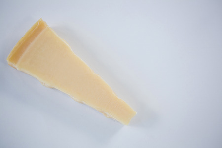 Close-up of piece of cheese on white backgroundの写真素材