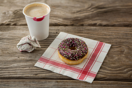 Close-up of doughnut and coffee on wooden plankの写真素材