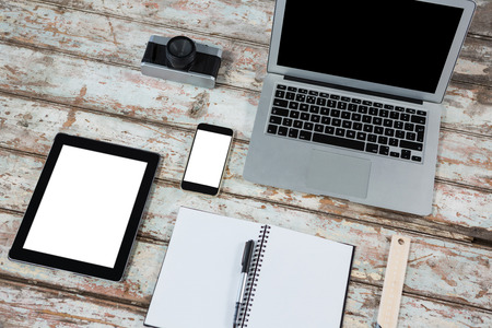 Laptop, digital tablet, smartphone with camera on tableの写真素材