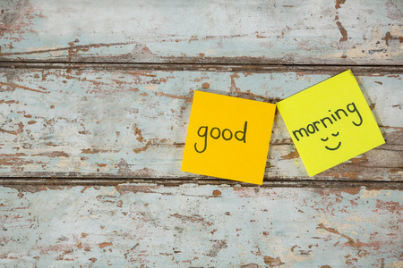 Text good morning with smiley face written on sticky note