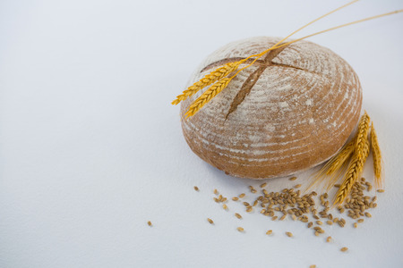 Bread loaf with wheat grain on white backgroundの写真素材