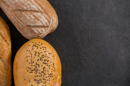 Close-up of bread loaves on black surface