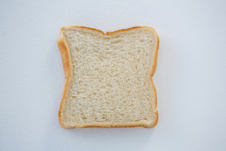 Close-up of single bread slice on white backgroundの写真素材