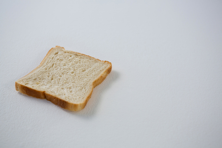 Close-up of single bread slice on white background