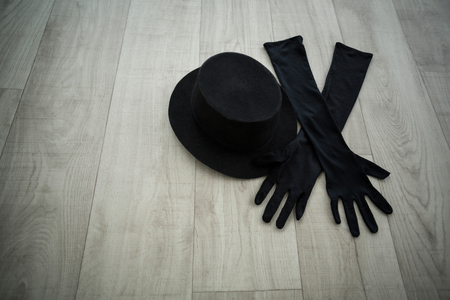 Close-up of bowler hat and black gloves in dance studioの写真素材