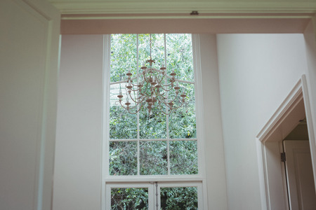 Chandelier hanging against window at home