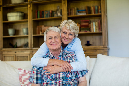 Portrait of senior couple embracing each other at homeの写真素材