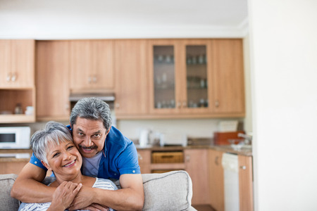 Portrait of senior couple embracing each other at homeの写真素材