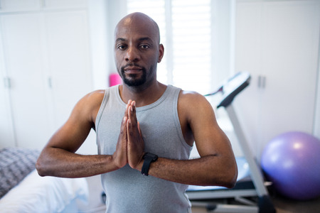 Portrait of man meditating at homeの写真素材