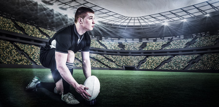 Rugby player ready to make a drop kick against rugby stadium with copy space 3dの写真素材