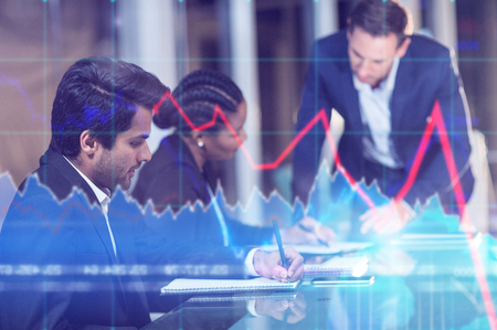 Financial chart with graph and arrows against businessman interacting with coworkers in meetingの写真素材