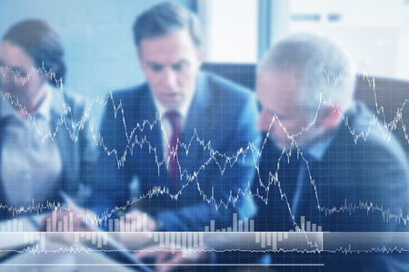 graph against business people sitting in conference room