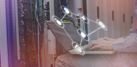 Smartphone apps icons against technician sitting on swivel chair using laptop to diagnose servers 3d