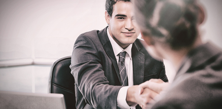 Manager interviewing a female applicant in his officeの写真素材