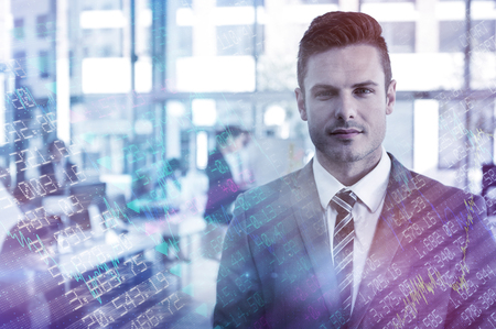 Stocks and shares against businessman standing in officeの写真素材