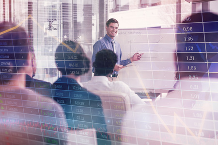 Stocks and shares against smiling businessman explaining colleagues