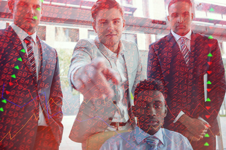 Stocks and shares against portrait of businessmen standing in officeの写真素材