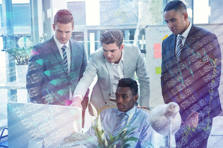 Stocks and shares against focused businessmen looking at computer
