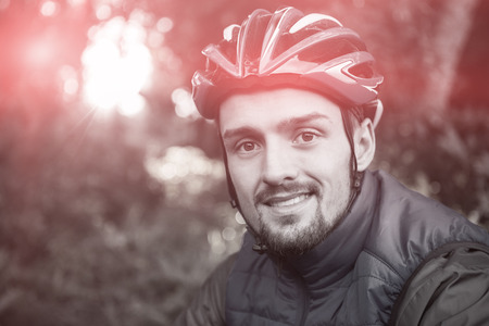 Portrait of male mountain biker in the forest on a sunny dayの写真素材