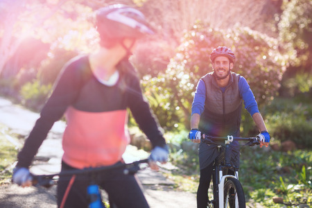 Biker couple cycling in countryside on a sunny dayの写真素材
