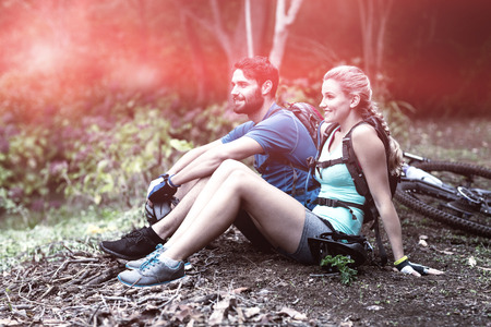 Smiling athletic couple relaxing in forestの写真素材