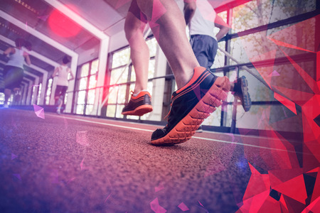 Athletic women and men running on indoor trackの写真素材