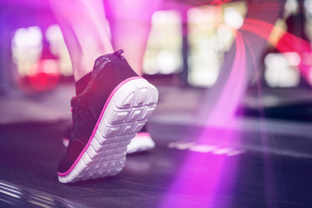 Cropped image of woman walking on machine at gymの写真素材