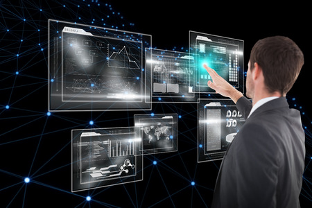 Focused businessman standing and pointing against business interface 3d