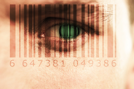 Composite image of Bar code  against close up of man with blue eyeの写真素材