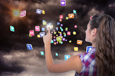 Pretty brunette pointing something with her finger  against gloomy sky 3dの写真素材