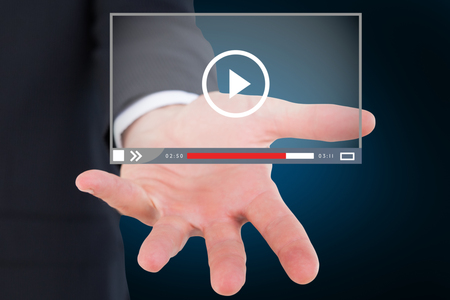 Mid section of a businessman with hands on a table against blue background with vignette 3dの写真素材
