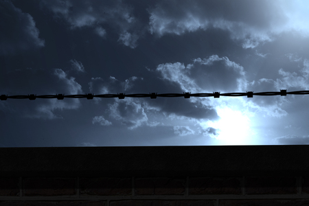 Panoramic illustration of barbed wire against cloudy skyの写真素材