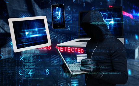 Hacker holding laptop and credir card against virus background