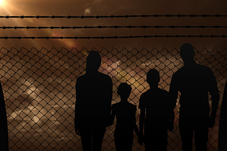 Portrait of happy family walking over white background against blue and orange sky with cloudsの写真素材